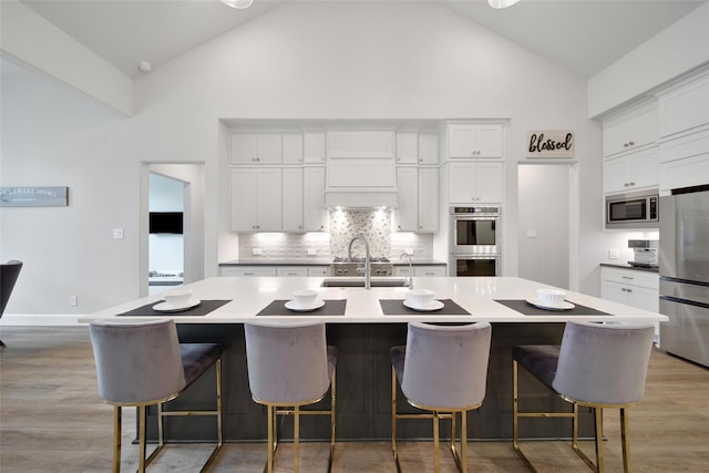 5350 Cherry Spring Dr, Spring, TX 77386 - kitchen with appliances with stainless steel finishes, high vaulted ceiling, backsplash, and white cabinets