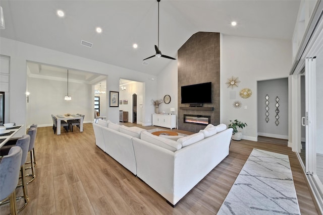 5350 Cherry Spring Dr, Spring, TX 77386 - living area featuring a fireplace, high vaulted ceiling, a ceiling fan, light wood-type flooring, and recessed lighting
