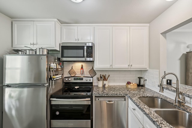 10676 Hazelhurst Dr, Houston, TX 77043 - kitchen featuring stainless steel appliances, stone counters, white cabinetry, and decorative backsplash