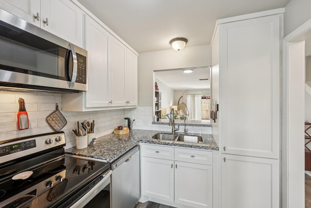10676 Hazelhurst Dr, Houston, TX 77043 - kitchen with stainless steel appliances, white cabinetry, decorative backsplash, and light stone counters
