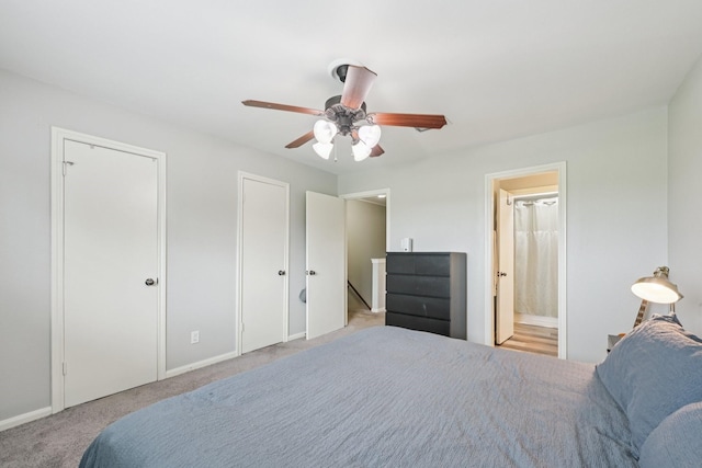 10676 Hazelhurst Dr, Houston, TX 77043 - bedroom featuring multiple closets, carpet floors, a ceiling fan, and connected bathroom