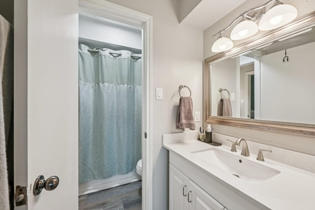 10676 Hazelhurst Dr, Houston, TX 77043 - bathroom featuring vanity, wood finished floors, and shower / bathtub combination with curtain