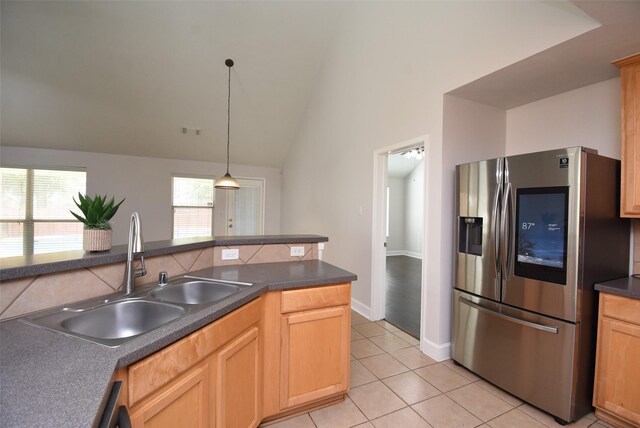 2611 Sandy Mist Ct, Katy, TX 77494 - kitchen featuring stainless steel refrigerator with ice dispenser, dark countertops, light tile patterned floors, vaulted ceiling, and hanging light fixtures