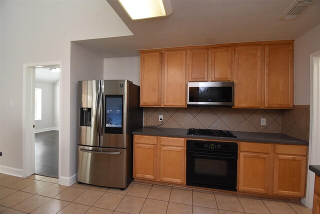 2611 Sandy Mist Ct, Katy, TX 77494 - kitchen featuring stainless steel appliances, dark countertops, and backsplash