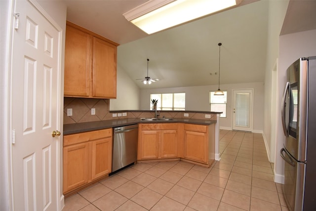 2611 Sandy Mist Ct, Katy, TX 77494 - kitchen with stainless steel appliances, a peninsula, light tile patterned floors, dark countertops, and lofted ceiling