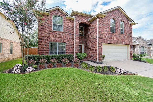 2611 Sandy Mist Ct, Katy, TX 77494 - traditional-style house featuring brick siding, concrete driveway, and an attached garage