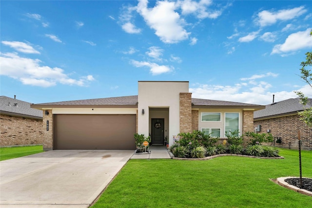 7902 Sleek Flock Ln, Rosharon, TX 77583 - view of front of home featuring a garage, brick siding, concrete driveway, and a front lawn