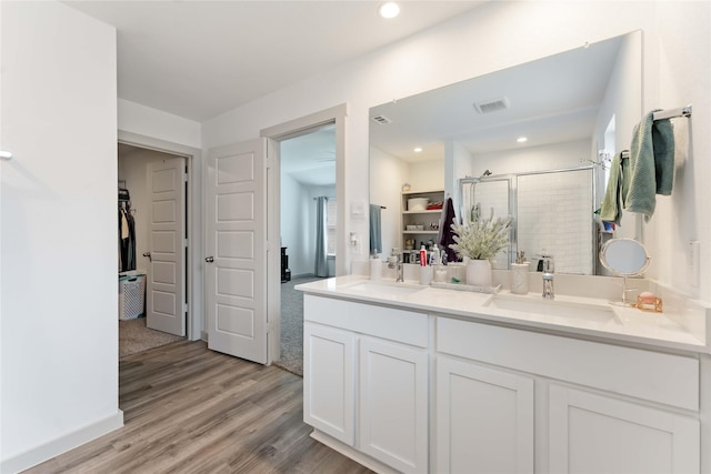 7902 Sleek Flock Ln, Rosharon, TX 77583 - full bath featuring a spacious closet, a stall shower, double vanity, wood finished floors, and recessed lighting