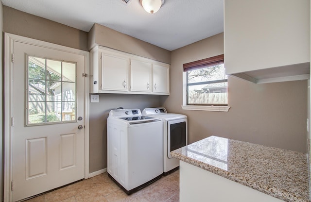 1511 Calveryman Ln, Katy, TX 77449 - laundry area featuring washing machine and dryer, cabinet space, and light tile patterned floors