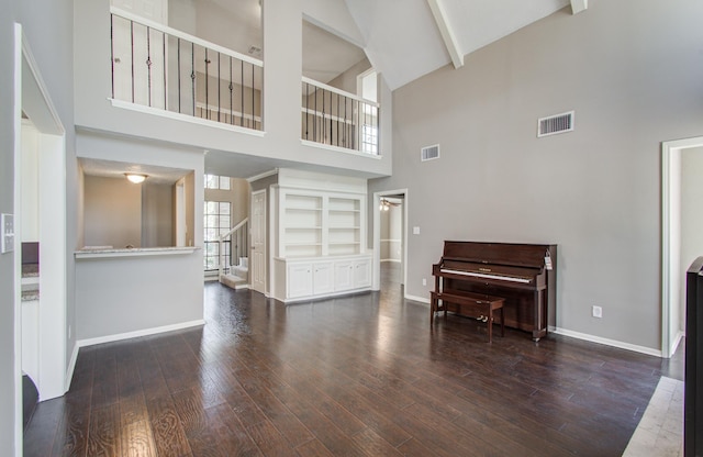 1511 Calveryman Ln, Katy, TX 77449 - living room featuring high vaulted ceiling, wood finished floors, beamed ceiling, built in shelves, and a ceiling fan