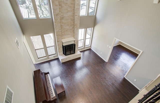 1511 Calveryman Ln, Katy, TX 77449 - unfurnished living room featuring a high ceiling, wood finished floors, and a high end fireplace