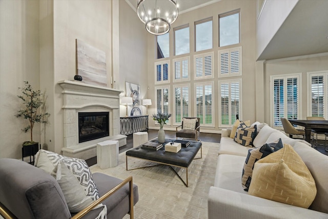 1923 Rice Mill Dr, Katy, TX 77493 - living room with a chandelier, a high ceiling, crown molding, a glass covered fireplace, and wood finished floors