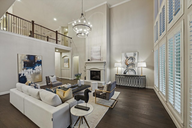 1923 Rice Mill Dr, Katy, TX 77493 - living area featuring a towering ceiling, a chandelier, plenty of natural light, wood finished floors, and ornamental molding