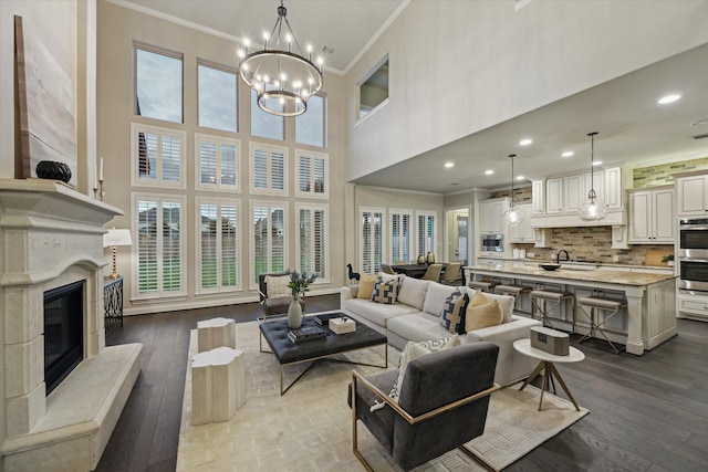 1923 Rice Mill Dr, Katy, TX 77493 - living area featuring ornamental molding, dark wood-type flooring, healthy amount of natural light, a premium fireplace, and recessed lighting