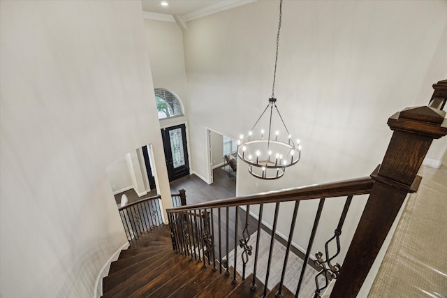 1923 Rice Mill Dr, Katy, TX 77493 - stairs featuring wood finished floors, a chandelier, a towering ceiling, and ornamental molding