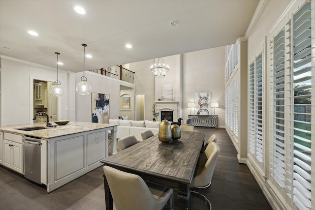 1923 Rice Mill Dr, Katy, TX 77493 - dining area with ornamental molding, recessed lighting, dark wood-style floors, a fireplace, and healthy amount of natural light