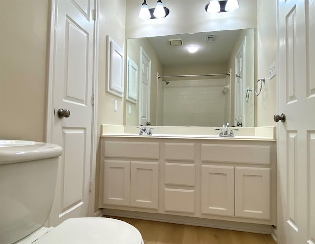 3210 Echo Mountain Dr, Houston, TX 77345 - bathroom featuring double vanity, a shower, and wood finished floors