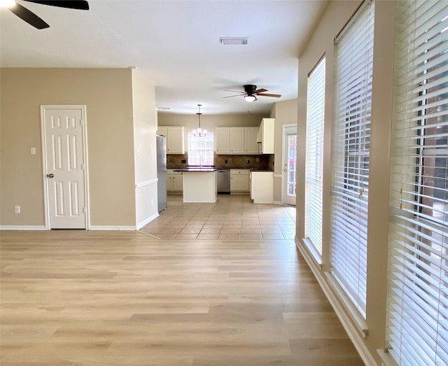 3210 Echo Mountain Dr, Houston, TX 77345 - unfurnished living room featuring a ceiling fan and light wood finished floors
