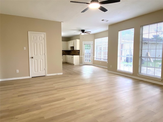 3210 Echo Mountain Dr, Houston, TX 77345 - unfurnished living room featuring a ceiling fan and light wood-style flooring
