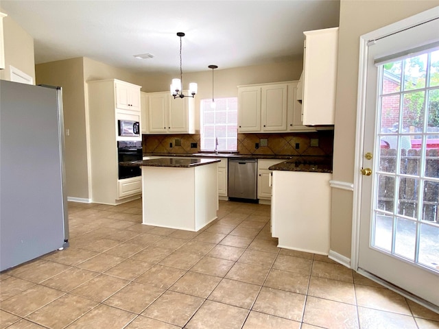 3210 Echo Mountain Dr, Houston, TX 77345 - kitchen featuring appliances with stainless steel finishes, tasteful backsplash, a chandelier, and dark countertops