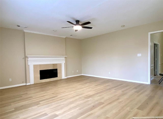 3210 Echo Mountain Dr, Houston, TX 77345 - unfurnished living room with ceiling fan, light wood-style flooring, a tile fireplace, and ornamental molding