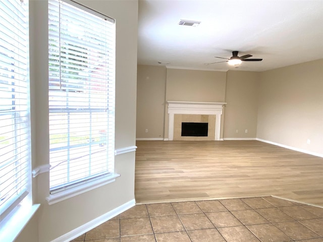3210 Echo Mountain Dr, Houston, TX 77345 - unfurnished living room with ceiling fan, tile patterned floors, and a tile fireplace