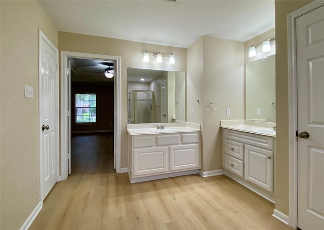 3210 Echo Mountain Dr, Houston, TX 77345 - full bathroom with wood finished floors, a stall shower, vanity, and a ceiling fan
