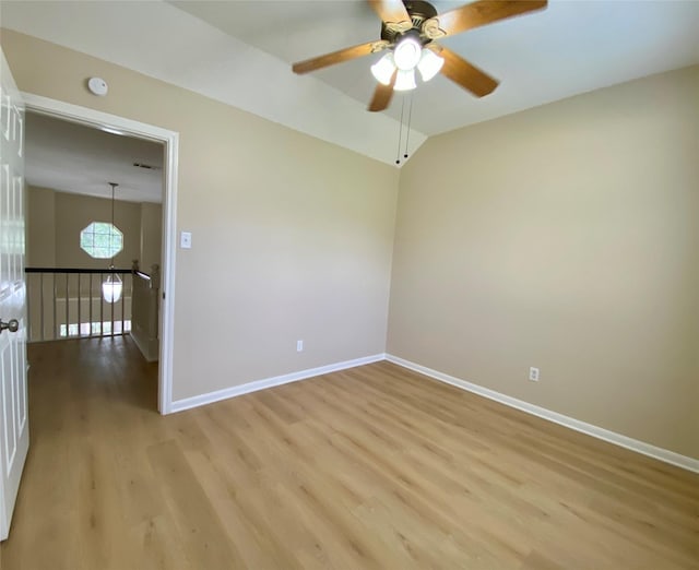 3210 Echo Mountain Dr, Houston, TX 77345 - unfurnished room with light wood-style flooring, ceiling fan, and vaulted ceiling