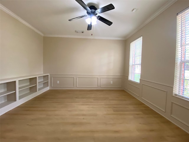 3210 Echo Mountain Dr, Houston, TX 77345 - spare room featuring plenty of natural light, light wood finished floors, ornamental molding, a decorative wall, and ceiling fan