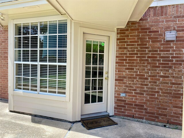 3210 Echo Mountain Dr, Houston, TX 77345 - doorway to property featuring brick siding