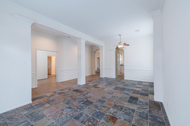 7314 Mountain Valley Dr, Houston, TX 77095 - spare room featuring a ceiling fan, stone tile floors, a decorative wall, a wainscoted wall, and arched walkways