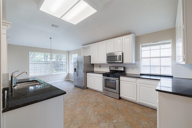 7314 Mountain Valley Dr, Houston, TX 77095 - kitchen with stainless steel appliances, white cabinets, pendant lighting, dark stone counters, and lofted ceiling