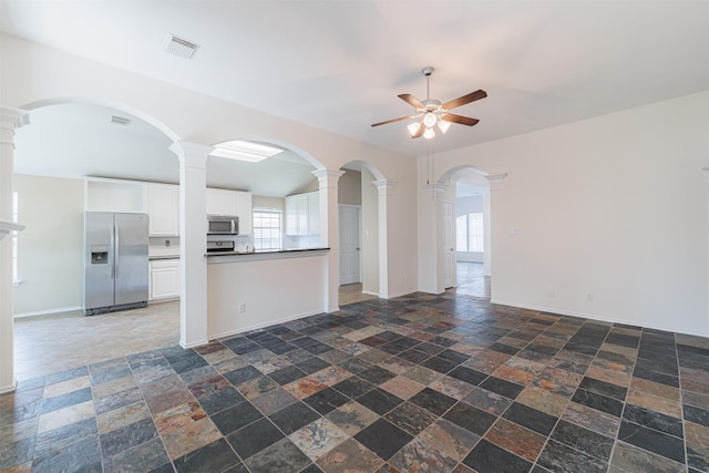 7314 Mountain Valley Dr, Houston, TX 77095 - unfurnished living room with ceiling fan, stone tile flooring, and ornate columns