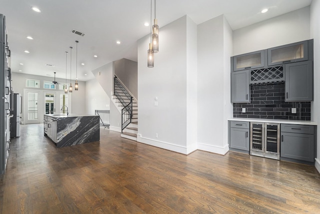 2221 Francis St, Houston, TX 77004 - living room featuring beverage cooler, a dry bar, dark wood-style floors, stairs, and recessed lighting