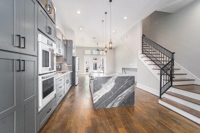 2221 Francis St, Houston, TX 77004 - kitchen featuring white appliances, light stone counters, dark wood-type flooring, a large island, and recessed lighting