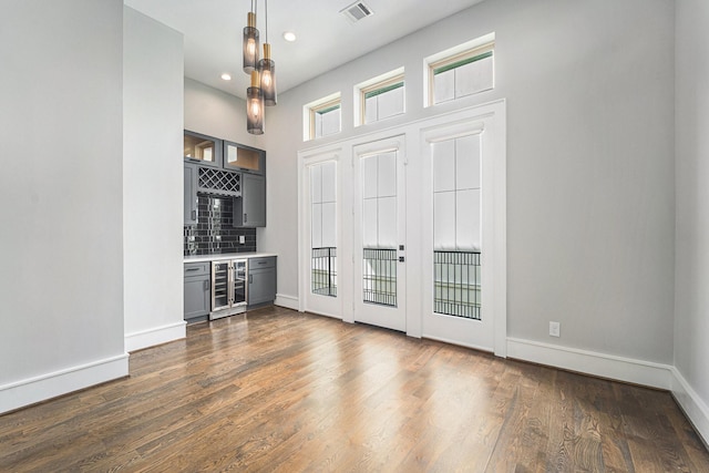 2221 Francis St, Houston, TX 77004 - spare room featuring dark wood-style floors, wine cooler, bar area, and recessed lighting
