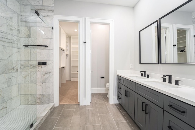 2221 Francis St, Houston, TX 77004 - bathroom featuring a walk in closet, double vanity, and a stall shower