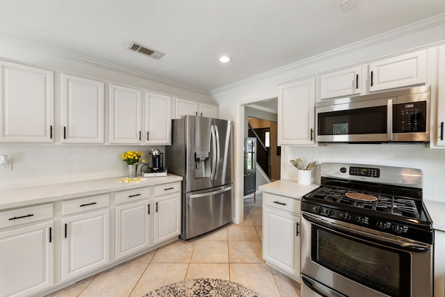 19 Shinyrock Pl, The Woodlands, TX 77381 - kitchen with appliances with stainless steel finishes, white cabinetry, light countertops, ornamental molding, and recessed lighting