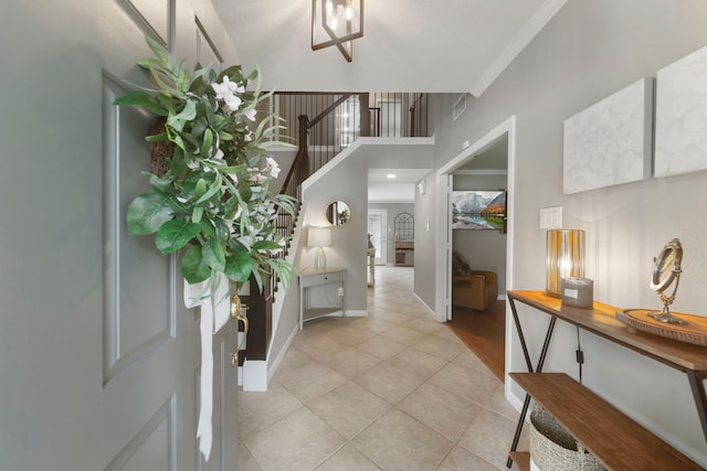 19 Shinyrock Pl, The Woodlands, TX 77381 - foyer entrance with light tile patterned floors, stairway, and crown molding