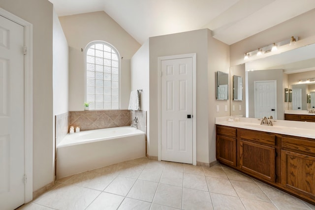 19 Shinyrock Pl, The Woodlands, TX 77381 - bathroom with vanity, a garden tub, vaulted ceiling, and tile patterned floors