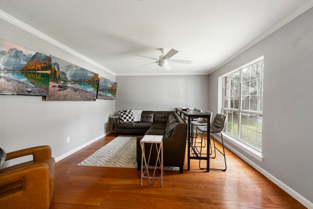 19 Shinyrock Pl, The Woodlands, TX 77381 - living room featuring a ceiling fan, ornamental molding, and wood finished floors