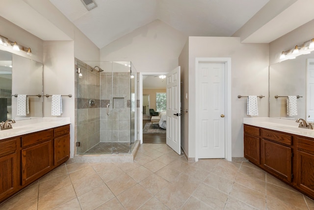 19 Shinyrock Pl, The Woodlands, TX 77381 - ensuite bathroom with two vanities, a shower stall, tile patterned flooring, and lofted ceiling