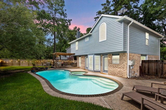 19 Shinyrock Pl, The Woodlands, TX 77381 - pool at dusk featuring an outdoor living space, a fenced backyard, a pergola, a patio, and a pool with connected hot tub