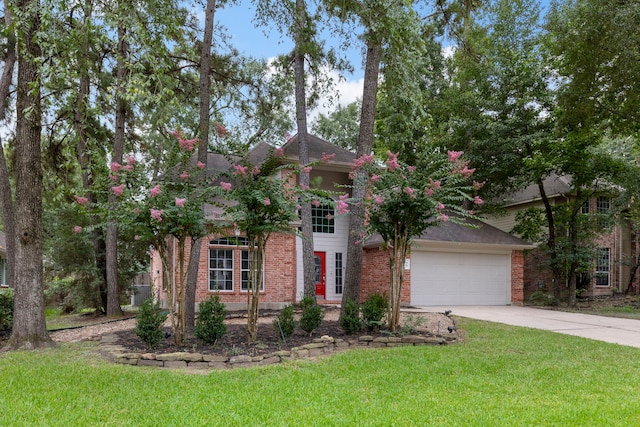96 N Acacia Park Cir, The Woodlands, TX 77382 - view of front of home with driveway, an attached garage, brick siding, and a front lawn