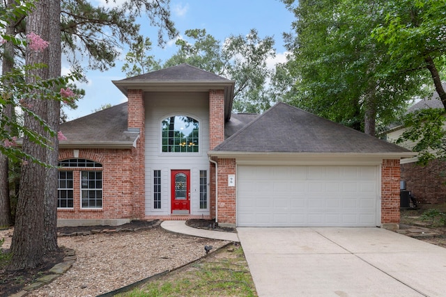96 N Acacia Park Cir, The Woodlands, TX 77382 - traditional home with a garage, driveway, brick siding, and a shingled roof