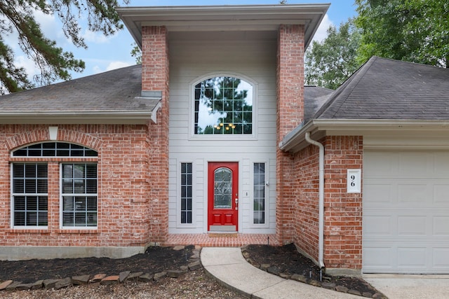 96 N Acacia Park Cir, The Woodlands, TX 77382 - doorway to property with a garage, a shingled roof, and brick siding