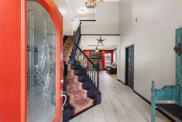 96 N Acacia Park Cir, The Woodlands, TX 77382 - foyer entrance featuring stairway, a towering ceiling, wood finished floors, and ceiling fan