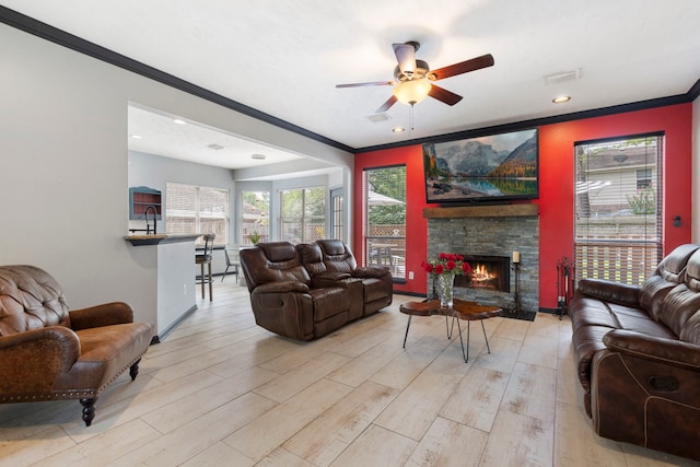 96 N Acacia Park Cir, The Woodlands, TX 77382 - living area featuring crown molding, ceiling fan, light wood finished floors, a fireplace, and recessed lighting