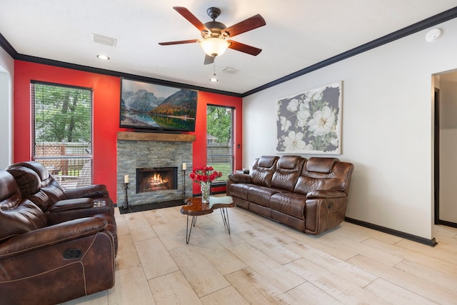 96 N Acacia Park Cir, The Woodlands, TX 77382 - living area with ornamental molding, a ceiling fan, a stone fireplace, light wood-style floors, and recessed lighting