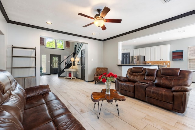 96 N Acacia Park Cir, The Woodlands, TX 77382 - living area with ceiling fan, ornamental molding, light wood finished floors, stairway, and recessed lighting